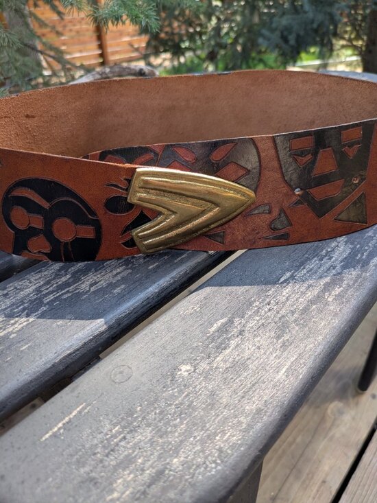 Artisanal hand-carved leather totem belt with brass v-tip Boho ethnic Tribal.